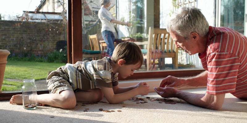 Grandpa talking about savings and superannuation to his grandson.